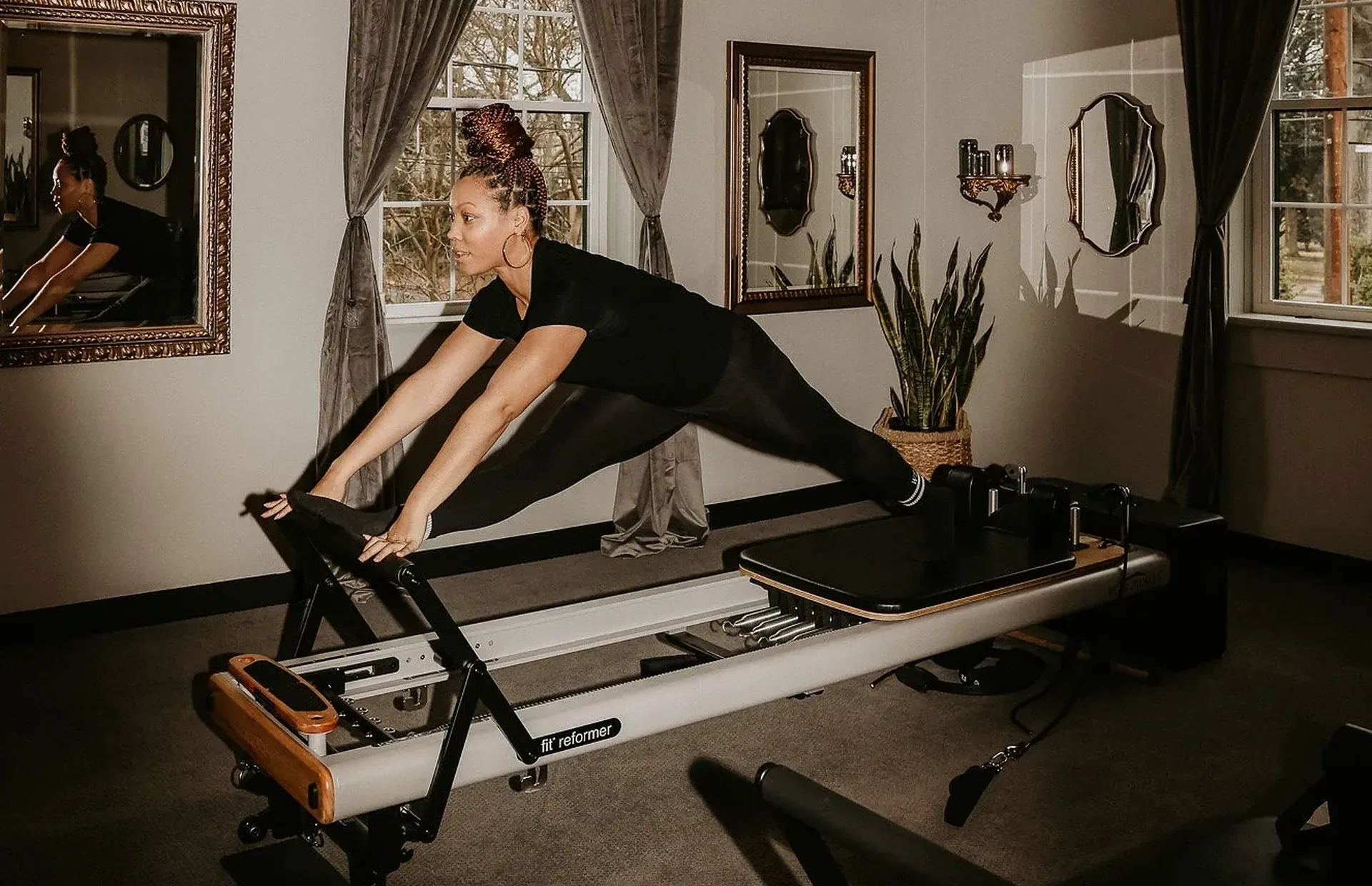 Reformer Pilates inside the warm boutique studio at Wellness Experience Pilates in Belmont, NC